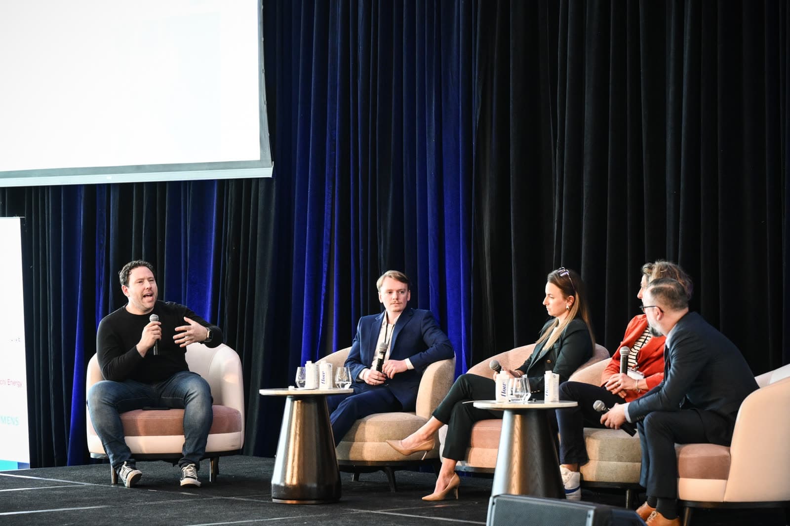 Panelists in discussion on stage at the AIEQ Forum