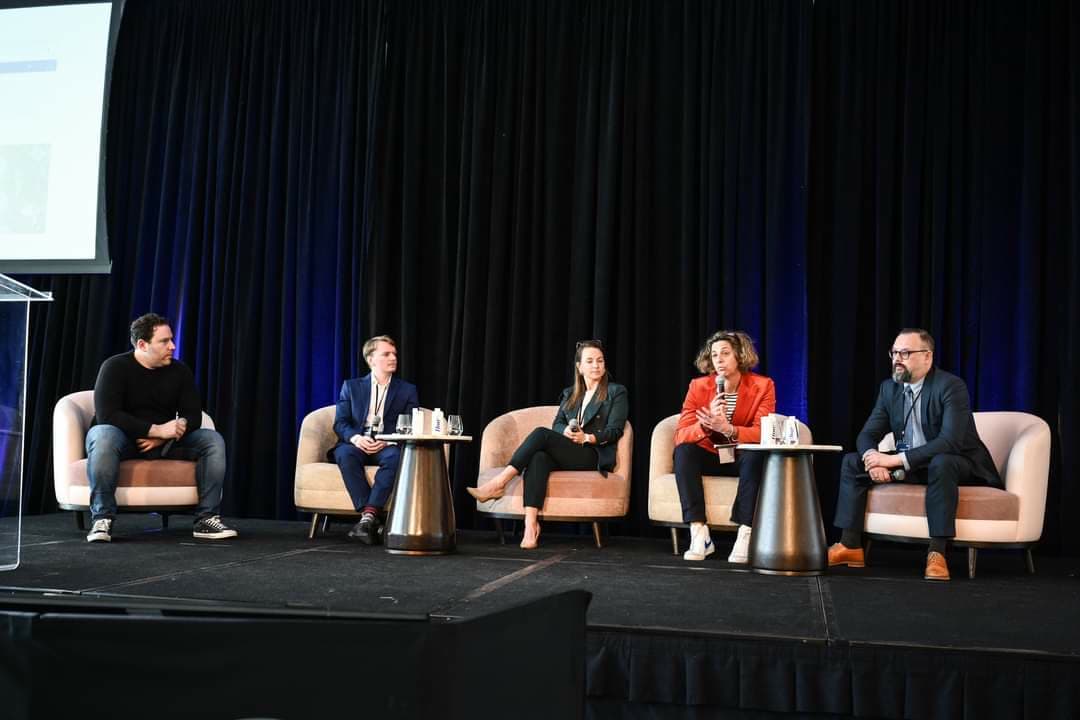 Five panelists on stage at the AIEQ Forum
